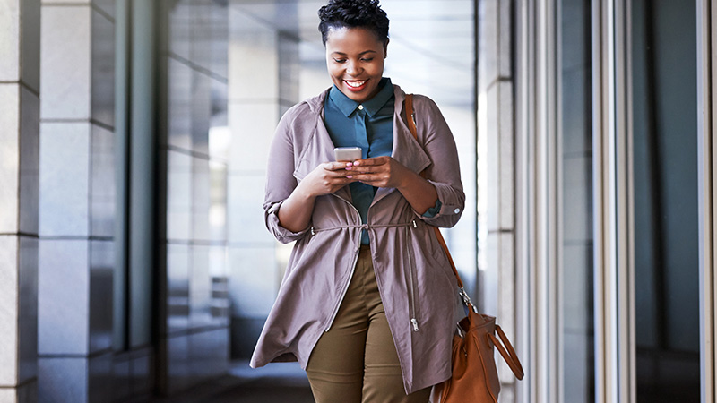 Woman smiling at a smart phone.