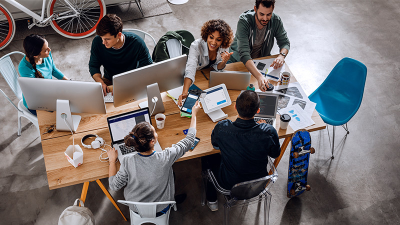 A group of people working at a conference table.