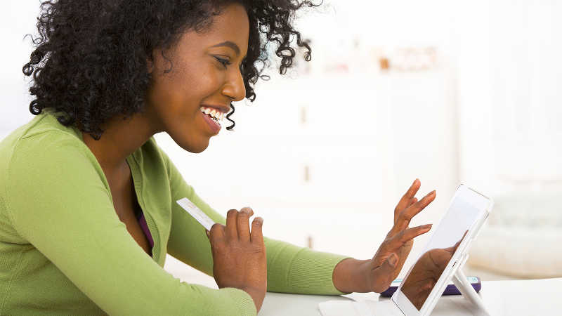 Woman using tablet computer at desk