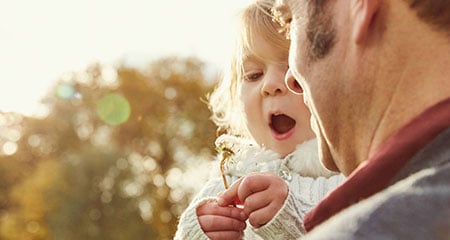 child playing with flower