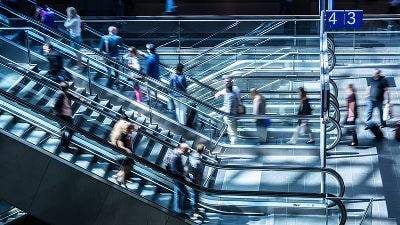 Group of people on up and down escalators