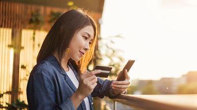 Woman uses a digital payment solution on her mobile phone
